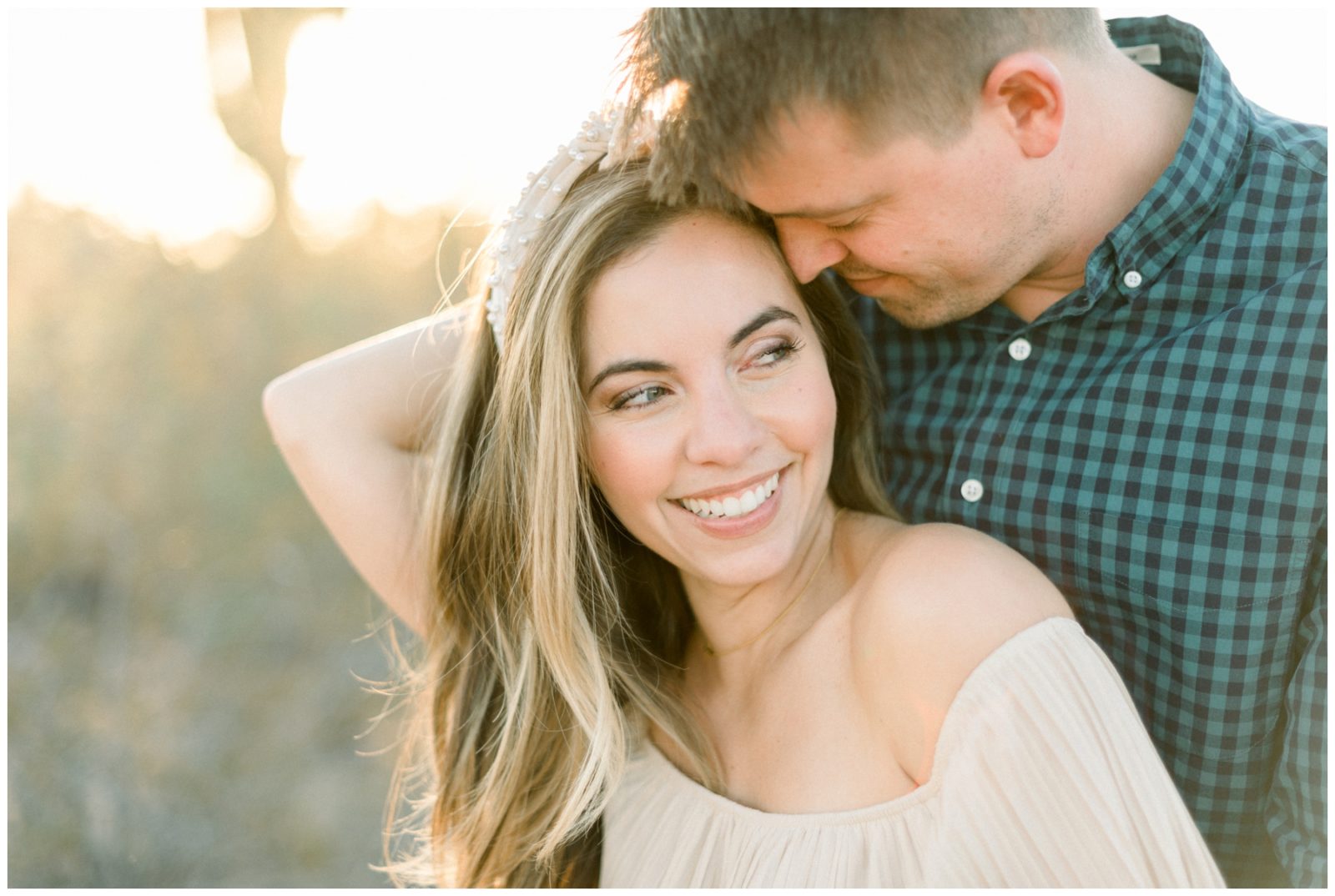 Couple cuddling and smiling during engagement photos