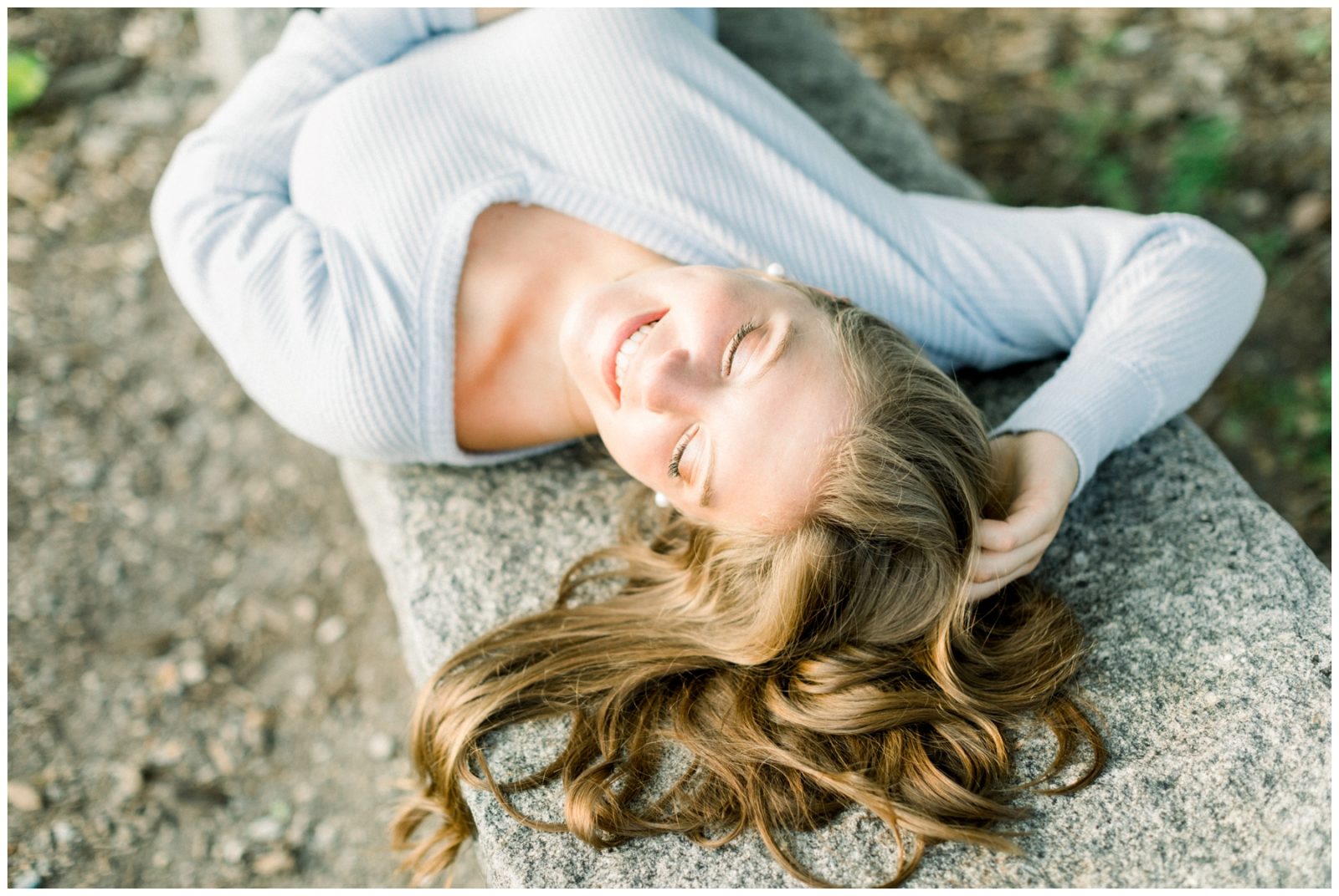 Golden Light Senior Session of a young girl laying down.